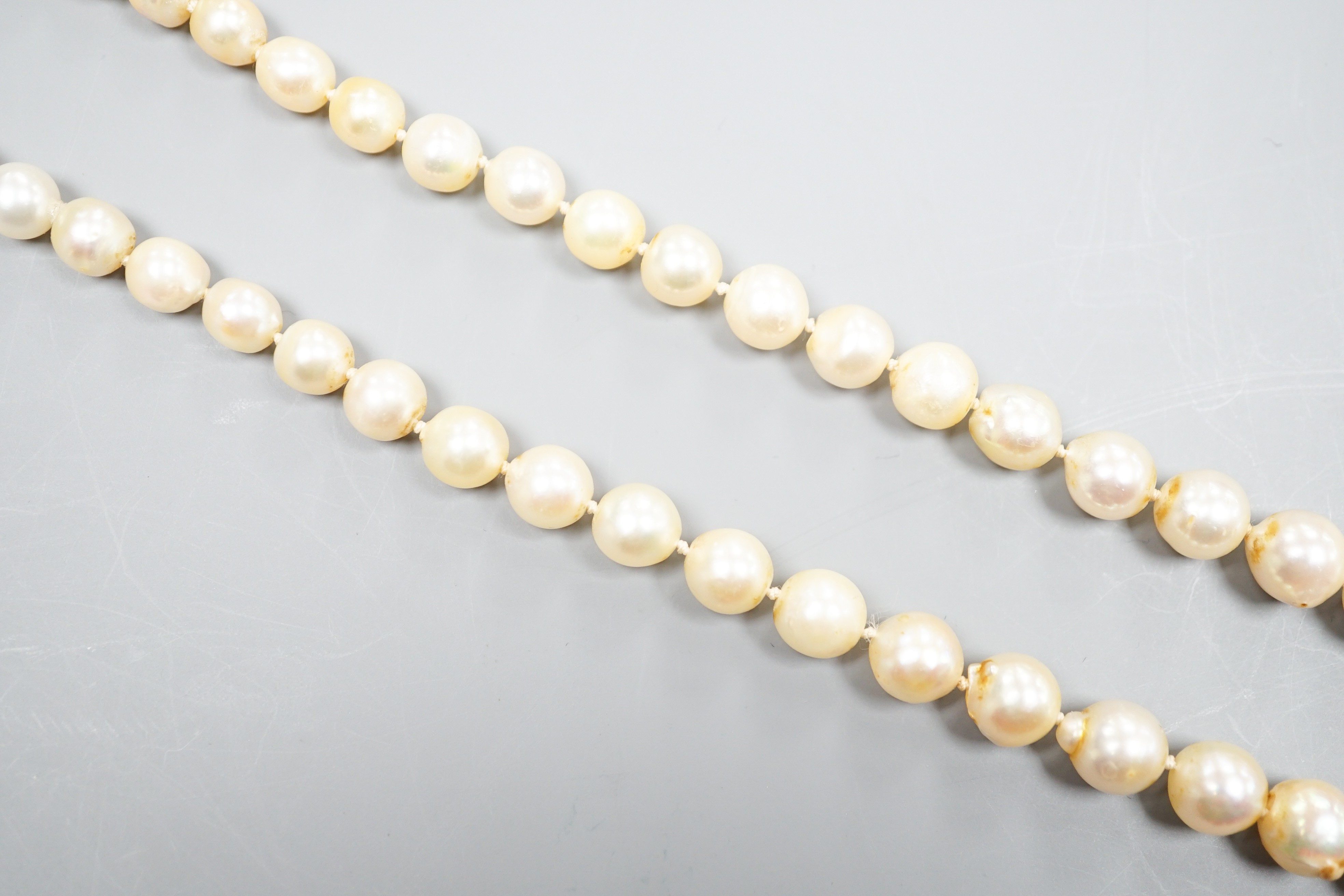 A single strand graduated pearl necklace (not tested for natural), with yellow metal and three stone diamond set clasp, 44cm.